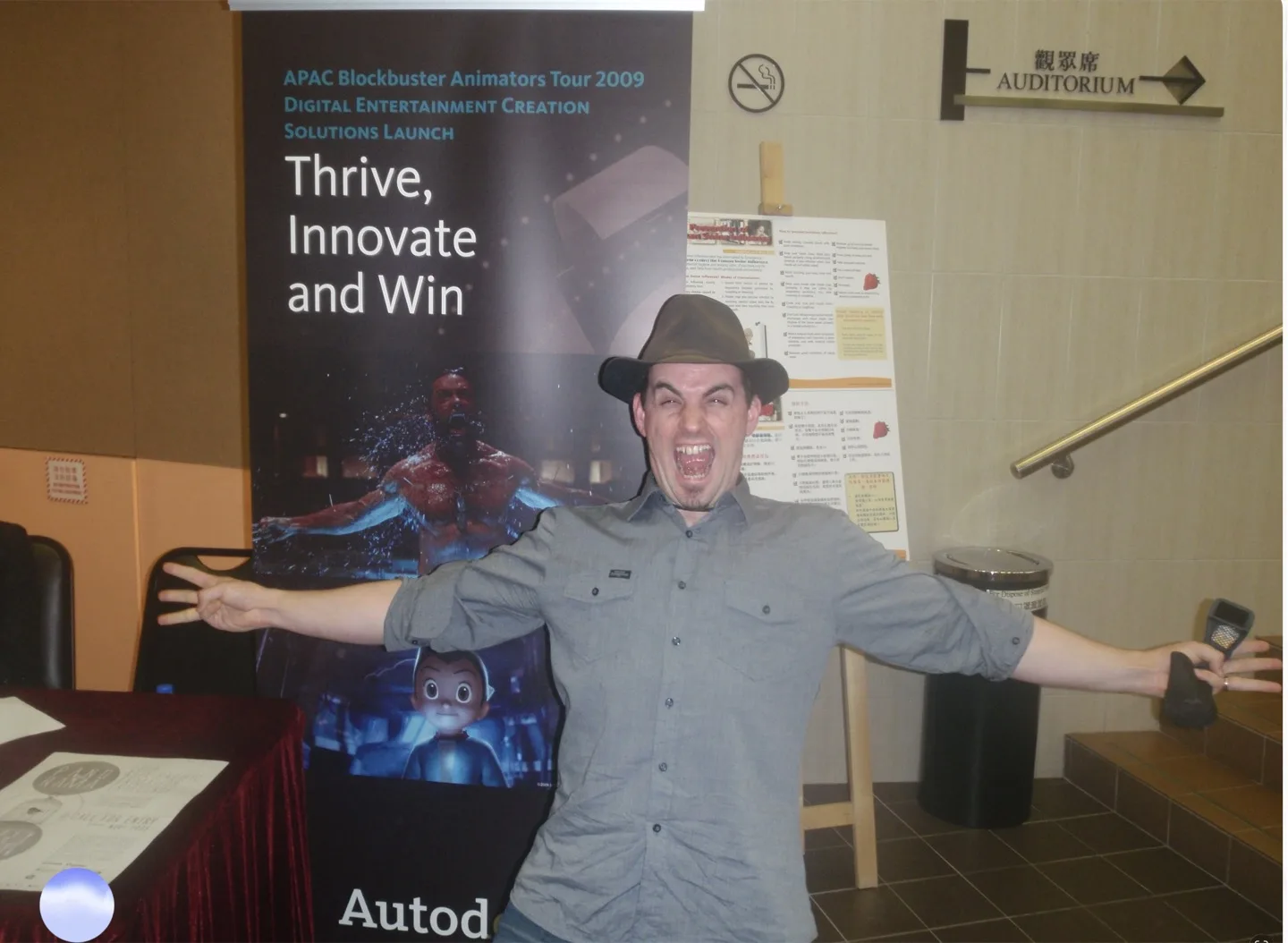 Ian Cope at the 2009 Autodesk APAC Blockbuster Animators Tour beside the Thrive, Innovate and Win event display
