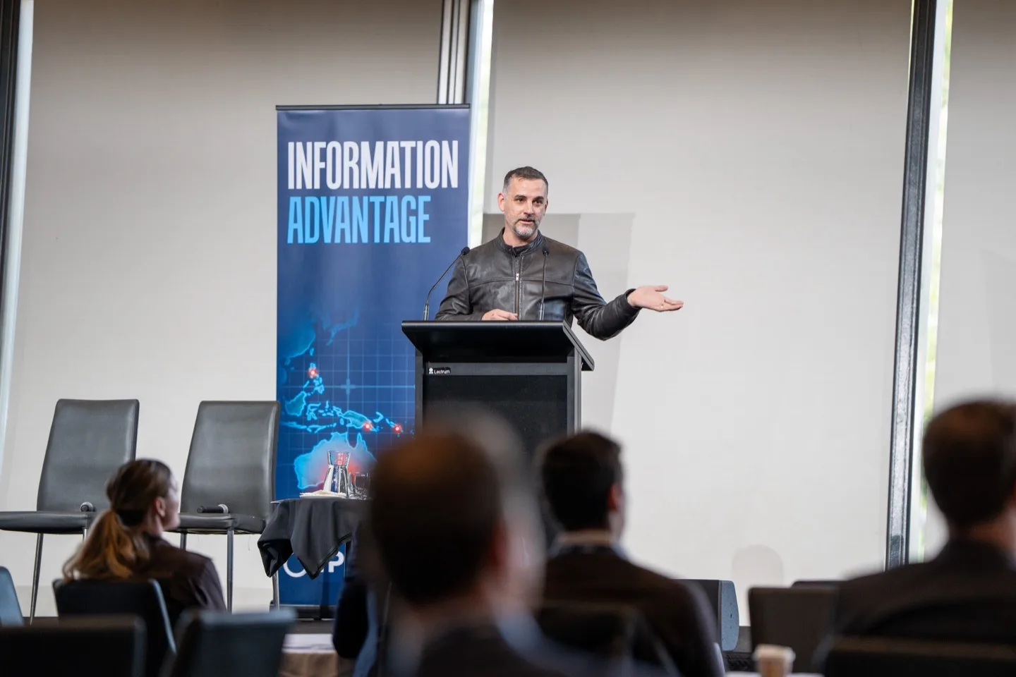 Ian Cope speaking at a podium during GISA 2026 in Adelaide